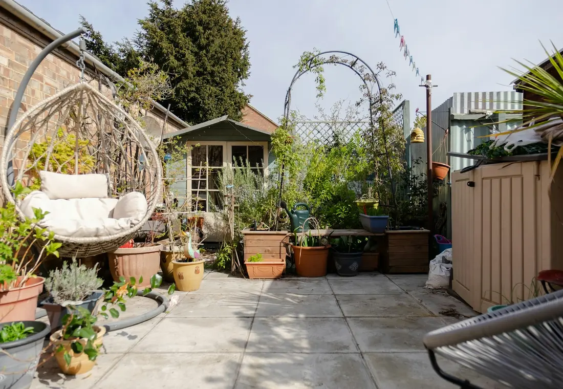 Compact courtyard garden with planting, seating and improved layout.